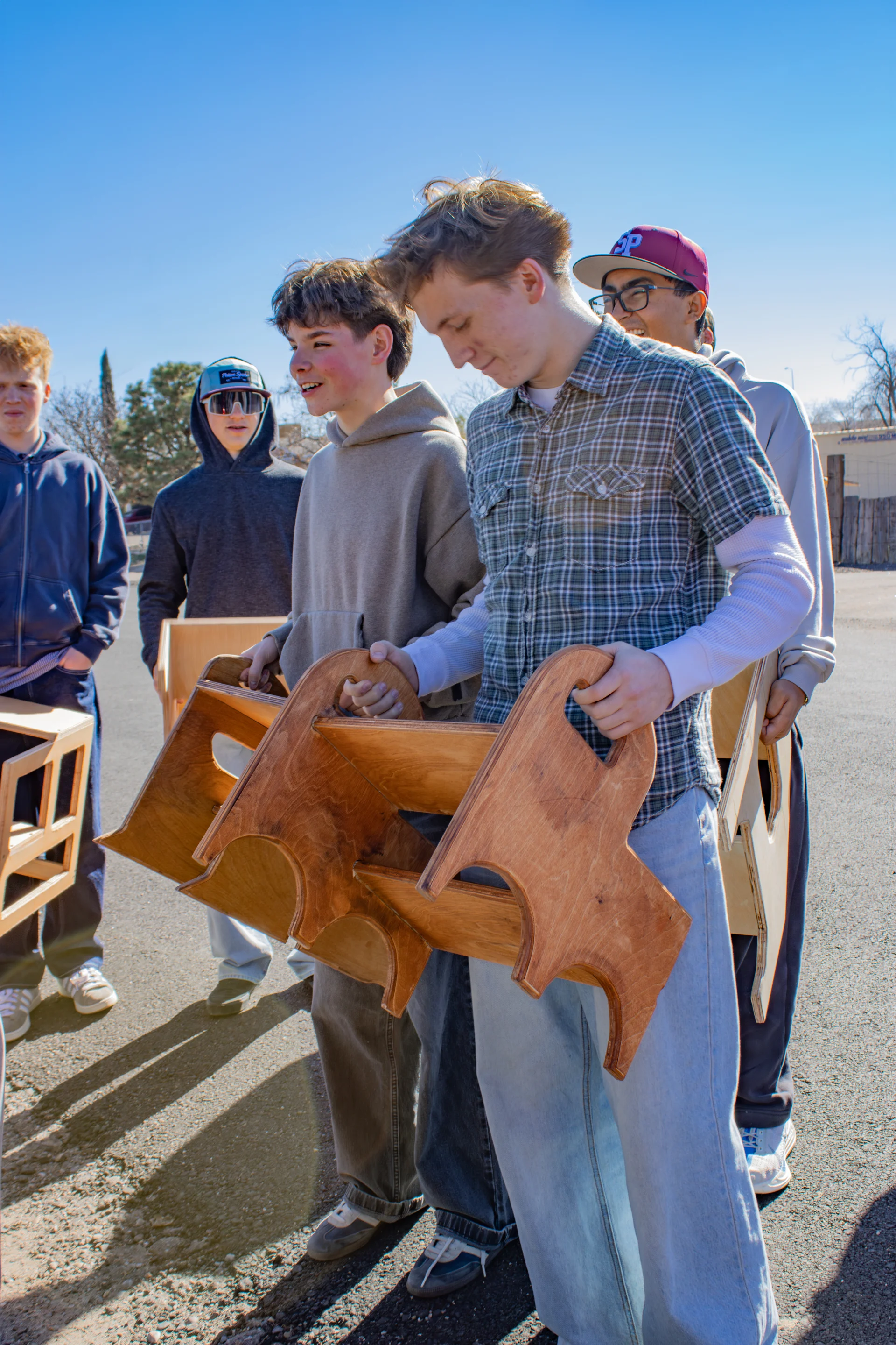 Studentscarrying step stools to car